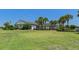 Large clubhouse on a lush green lawn with palm trees at 13618 Sw 111Th Cir, Dunnellon, FL 34432