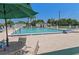 Community pool with covered tables and chairs poolside for residents to relax and enjoy the sunshine at 13618 Sw 111Th Cir, Dunnellon, FL 34432