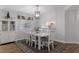 This dining area features a chandelier, white table, and hardwood floors at 13618 Sw 111Th Cir, Dunnellon, FL 34432