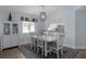 Bright dining area featuring modern lighting, white table, and cabinet for storage at 13618 Sw 111Th Cir, Dunnellon, FL 34432