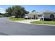 Charming single-story home featuring a screen garage, lush landscaping, and inviting curb appeal at 13618 Sw 111Th Cir, Dunnellon, FL 34432