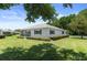 Well-maintained home with green shutters, surrounded by lush landscaping at 13618 Sw 111Th Cir, Dunnellon, FL 34432