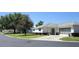 Charming single-story home featuring a screen garage, lush landscaping, and inviting curb appeal at 13618 Sw 111Th Cir, Dunnellon, FL 34432