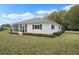 Inviting single-story home featuring an enclosed sunroom and lush landscaping at 13618 Sw 111Th Cir, Dunnellon, FL 34432