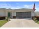 Beautiful one-story home featuring a large garage and an inviting entrance with fresh landscaping at 13618 Sw 111Th Cir, Dunnellon, FL 34432