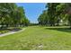 Scenic golf course view featuring lush green grass and mature trees on a clear, sunny day at 13618 Sw 111Th Cir, Dunnellon, FL 34432