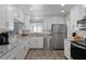 Modern kitchen with white cabinets, stainless steel appliances, and granite countertops at 13618 Sw 111Th Cir, Dunnellon, FL 34432