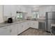 Modern kitchen with white cabinets, stainless steel appliances, and granite countertops at 13618 Sw 111Th Cir, Dunnellon, FL 34432