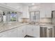 Charming kitchen featuring stainless steel appliances, stone countertops and light hardwood floors at 13618 Sw 111Th Cir, Dunnellon, FL 34432