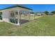 Outdoor lawn bowling area with covered seating, well maintained grass, and manicured landscaping at 13618 Sw 111Th Cir, Dunnellon, FL 34432