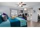 Bright bedroom featuring stylish decor, ceiling fan, hardwood flooring, and a sunny desk work area at 13618 Sw 111Th Cir, Dunnellon, FL 34432