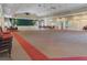 Large meeting hall featuring a stage, neutral colors, and tables with seating at 13618 Sw 111Th Cir, Dunnellon, FL 34432