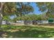 Community RV and trailer storage area with mature trees and green space at 13618 Sw 111Th Cir, Dunnellon, FL 34432