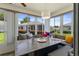 Bright sunroom with ample windows and a built-in dining nook at 13618 Sw 111Th Cir, Dunnellon, FL 34432