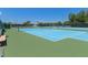 Outdoor tennis courts featuring well maintained blue playing surface, green trim and tall net at 13618 Sw 111Th Cir, Dunnellon, FL 34432