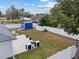 Aerial shot of a fully fenced in backyard features a patio, storage shed, and well-manicured lawn at 14118 Sw 32Nd Terrace Rd, Ocala, FL 34473