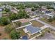 Aerial view of home features fenced-in backyard, shed, patio, mature trees, and neighborhood setting at 14118 Sw 32Nd Terrace Rd, Ocala, FL 34473