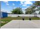 A well-maintained backyard features a patio, a lawn, and a blue storage shed behind a white vinyl fence at 14118 Sw 32Nd Terrace Rd, Ocala, FL 34473