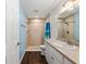 Bright bathroom featuring a walk-in shower with a blue accent wall at 14118 Sw 32Nd Terrace Rd, Ocala, FL 34473