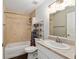 A modern bathroom features tiled walls, a shower over tub, and a vanity with sink and a mirror at 14118 Sw 32Nd Terrace Rd, Ocala, FL 34473