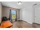A cozy bedroom features hardwood floors, a white closet door, and a window letting in natural light at 14118 Sw 32Nd Terrace Rd, Ocala, FL 34473