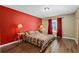 Cozy bedroom with a decorative bedspread, side tables with lamps, and wood floor at 14118 Sw 32Nd Terrace Rd, Ocala, FL 34473
