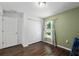 A bright bedroom features laminate floors, a double door closet, and a large window at 14118 Sw 32Nd Terrace Rd, Ocala, FL 34473