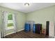 This bedroom features laminate floors, a window with curtains, and a pleasant green paint at 14118 Sw 32Nd Terrace Rd, Ocala, FL 34473
