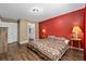Comfortable bedroom featuring a bed, side tables, and wood flooring at 14118 Sw 32Nd Terrace Rd, Ocala, FL 34473