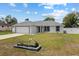 Charming single-story home with an attached garage, meticulous lawn, and cute flower bed at 14118 Sw 32Nd Terrace Rd, Ocala, FL 34473