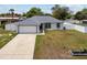 Charming single-story home with a well-manicured lawn, attached garage, and a white picket fence at 14118 Sw 32Nd Terrace Rd, Ocala, FL 34473