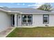 Close up of charming single-story home with a meticulously manicured lawn and front patio at 14118 Sw 32Nd Terrace Rd, Ocala, FL 34473