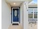 Close up of Front Door with glass detail and manicured lawn and cozy front patio area at 14118 Sw 32Nd Terrace Rd, Ocala, FL 34473