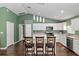 Modern kitchen with white cabinetry, stainless appliances, and a stylish island with seating at 14118 Sw 32Nd Terrace Rd, Ocala, FL 34473