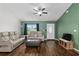 Welcoming living room with modern seating, hardwood floors, ceiling fan, and neutral wall color at 14118 Sw 32Nd Terrace Rd, Ocala, FL 34473