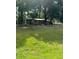Quaint single-story home featuring a lush green lawn and charming wooden fence at 14121 Nw Highway 225, Reddick, FL 32686