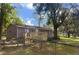 Charming single-story home featuring a covered porch, wood siding, and a well-maintained front yard with mature trees at 14121 Nw Highway 225, Reddick, FL 32686