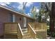 Inviting front porch with wood railings and stairs, offering a warm welcome to this charming single-Gathering home at 14121 Nw Highway 225, Reddick, FL 32686