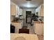 Galley kitchen with stainless steel appliances, white cabinets and eat-in space for modern Gathering meals at 14121 Nw Highway 225, Reddick, FL 32686