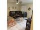 Spacious living room with large sectional sofa, colorful floral rug and natural light at 14121 Nw Highway 225, Reddick, FL 32686