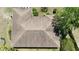 Birds eye view of a brown shingle roof with box gutters on a single story home surrounded by trees at 15920 Sw 49Th Court Rd, Ocala, FL 34473