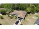 Aerial view of single-story home with a brown roof, screened lanai, and black SUV in driveway at 15920 Sw 49Th Court Rd, Ocala, FL 34473