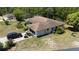 Aerial view of a single-story home featuring a brown roof, screened in lanai, and black SUV at 15920 Sw 49Th Court Rd, Ocala, FL 34473