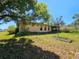 View of the backyard with mature trees and a screened-in porch at 15920 Sw 49Th Court Rd, Ocala, FL 34473