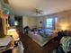 Cozy bedroom with a ceiling fan and a view of the exterior at 15920 Sw 49Th Court Rd, Ocala, FL 34473