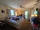Bedroom with large windows, ceiling fan and view of the outdoors at 15920 Sw 49Th Court Rd, Ocala, FL 34473