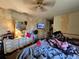 This bedroom features a large window and a ceiling fan at 15920 Sw 49Th Court Rd, Ocala, FL 34473
