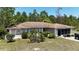 Single story home with neutral paint, brown roof, decorative shrubs, and a screened in lanai at 15920 Sw 49Th Court Rd, Ocala, FL 34473