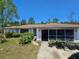 Charming single-story home with a cozy, inviting front screened-in porch at 15920 Sw 49Th Court Rd, Ocala, FL 34473