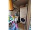 Functional laundry area equipped with a washer, dryer, sink, and storage space for convenience at 15920 Sw 49Th Court Rd, Ocala, FL 34473